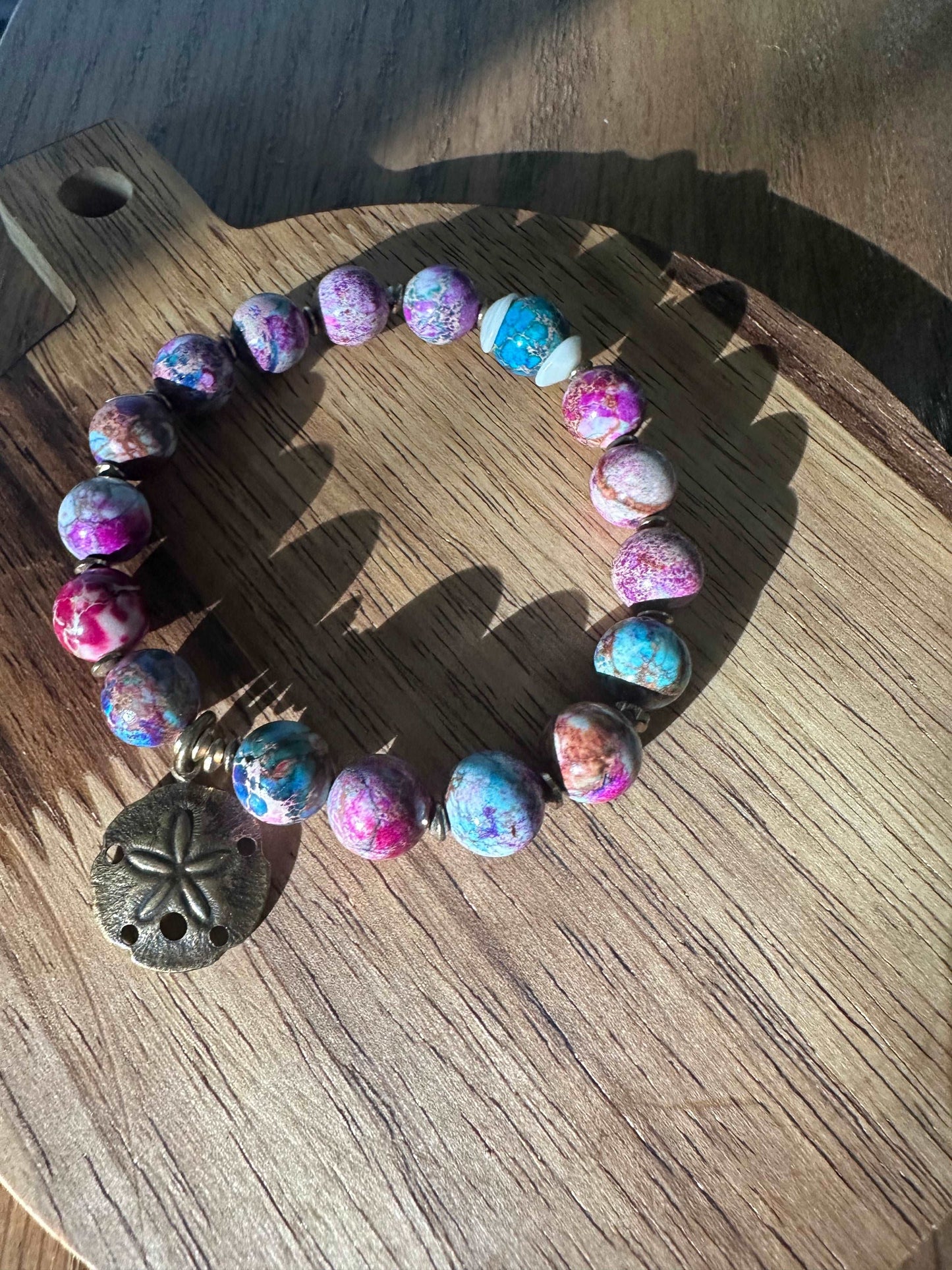 Colorful beaded bracelet with sand dollar charm