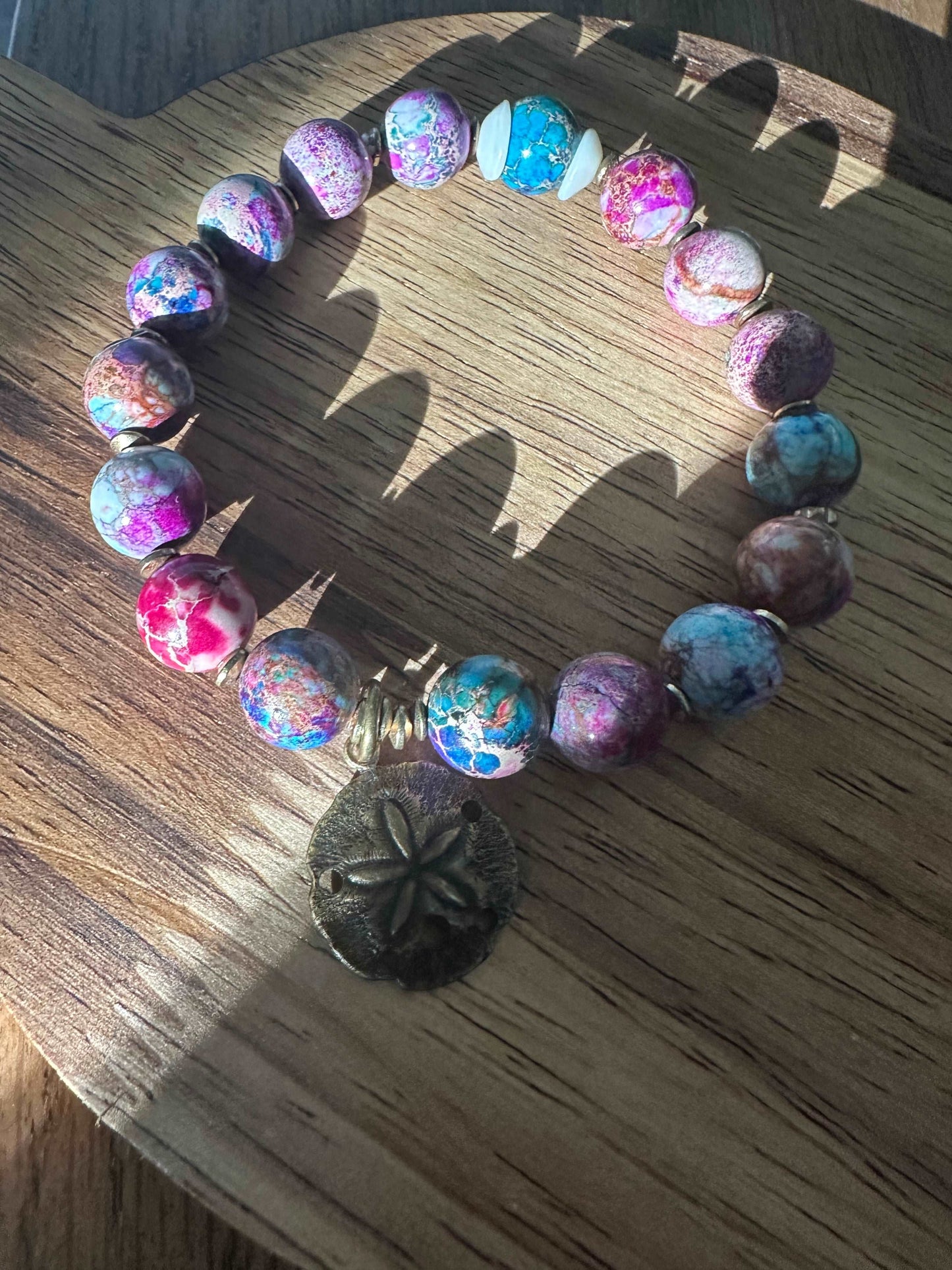 Colorful beaded bracelet with sand dollar charm