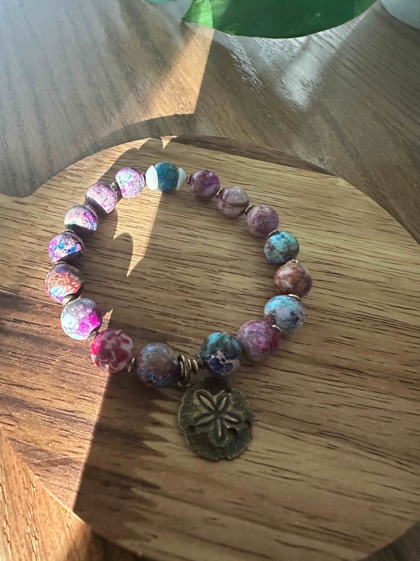 Colorful beaded bracelet with sand dollar charm